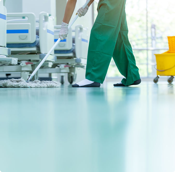 Cropped image of commercial cleaner in green pants providing medical office cleaning in Nashville.